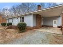 Close up shot of a quaint home with covered parking and a well kept front lawn at 2670 Turner Rd, Mebane, NC 27302