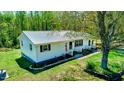 Lovely single-story home with black shutters, a metal roof, an American flag, and a beautifully landscaped front yard at 2700 Chub Lake Rd, Roxboro, NC 27574