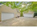 View of a large three car garage and separate one car garage with ample parking at 2900 Old Trafford Way, Raleigh, NC 27606