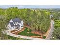 Breathtaking aerial view showcasing the property's serene location surrounded by lush greenery and mature trees at 30 Mist Wood Ct, Pittsboro, NC 27312