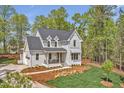 Stunning home with elegant architecture, showcasing manicured landscaping and a well-designed driveway at 30 Mist Wood Ct, Pittsboro, NC 27312