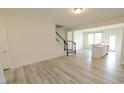 Bright and spacious living area with hardwood floors and staircase at 3007 Cypress Lagoon Ct, Durham, NC 27703