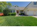 Charming home featuring a red front door, attached garages, well-manicured lawn and inviting front porch seating area at 308 Grove Hall Ln, Mebane, NC 27302