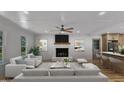 Bright living room features a fireplace, ceiling fan, and seamless flow into the adjacent kitchen area at 3100 Greenville Loop Rd, Wake Forest, NC 27587