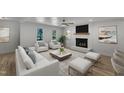 Cozy living room with white sofas, a fireplace, and a large area rug for a comfortable gathering space at 3100 Greenville Loop Rd, Wake Forest, NC 27587
