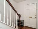 Bright entryway featuring white walls, hardwood floors, with stairs and coat closet at 3125 Morningside Dr, Raleigh, NC 27607