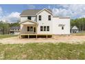 The back of the home displays an open-air porch and multiple windows for lots of natural light at 317 Hampshire Court, Four Oaks, NC 27524