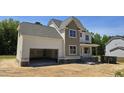 Charming two-story home with a modern farmhouse exterior design and an attached two car garage at 317 Hampshire Court, Four Oaks, NC 27524