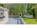 Spacious gray back deck with seating area, perfect for enjoying outdoor living and the yard at 322 W Hill N Ave, Hillsborough, NC 27278