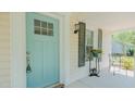 Cozy front porch view showcasing the light-blue door and decorative details at 322 W Hill N Ave, Hillsborough, NC 27278