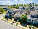 Aerial view showcasing the neighborhood with well-maintained homes and lush greenery at 379 Tobacco Farm Way, Chapel Hill, NC 27516