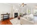 Inviting living room featuring a cozy fireplace, elegant decor, and ample natural light with hardwood flooring at 379 Tobacco Farm Way, Chapel Hill, NC 27516