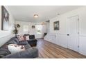 Cozy living room with wood floors, wainscoting, and comfortable seating for relaxing or entertaining guests at 411 Lawton Dr, Haw River, NC 27258