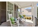 Cozy front porch featuring rocking chairs with stylish pillows on a stone floor, great for relaxing outdoors at 4213 Summer Brook Dr, Apex, NC 27539