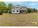 Charming two-story home with a covered porch, classic colors, and a spacious front yard at 4228 Nc 42 Hwy, Raleigh, NC 27603