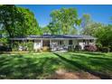 Charming single-story home showcasing manicured landscaping and a well-maintained front lawn at 4902 Brookhaven Dr, Raleigh, NC 27612