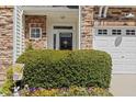 Inviting front entrance adorned with a spring wreath and colorful flowers at 4924 Amber Clay Ln, Raleigh, NC 27612