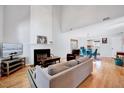 Bright living room with high ceilings, a cozy fireplace, and seamless flow into the dining area at 5016 Silhouette Dr, Durham, NC 27713