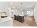 Open-concept kitchen with stainless steel appliances, a center island, and sleek, light-colored countertops at 502 Gainer Dr # 2, Raleigh, NC 27610