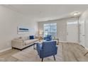 Inviting living room with a comfortable beige sofa, blue accent chairs, and ample natural light at 5110 Neuse Commons Ln # 109, Raleigh, NC 27616