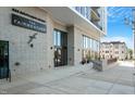 Building entrance with modern architecture, well-maintained landscaping, and brick facade at 523 S West St # 404, Raleigh, NC 27601