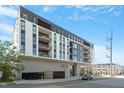 Modern condo building with sleek design and multiple balconies against a blue sky at 523 S West St # 404, Raleigh, NC 27601