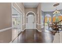 Elegant foyer with hardwood floors and a graceful arched entryway with views to the dining room at 5408 Colonial Oaks Dr, Apex, NC 27539