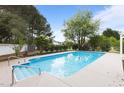 Inviting in-ground pool with a clear blue water, set in a spacious yard with mature landscaping at 5408 Colonial Oaks Dr, Apex, NC 27539