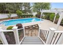 Beautiful backyard pool with a paved patio and elegant pergola, perfect for outdoor entertaining at 5408 Colonial Oaks Dr, Apex, NC 27539
