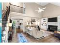 Inviting living room with soaring ceilings, fireplace, and a staircase leading to the second floor at 5911 Mountain Island Dr, Durham, NC 27713