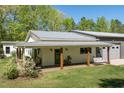 Relaxing covered front porch with comfortable seating and a charming porch swing at 605 Faucette Mill Rd, Hillsborough, NC 27278