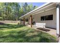A welcoming porch with a wooden porch swing at 605 Faucette Mill Rd, Hillsborough, NC 27278