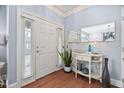 Bright foyer featuring hardwood floors, elegant console table, and decorative mirror at 608 Derby Ct, Durham, NC 27707