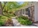 A well-maintained brick home with lovely landscaping and a welcoming walkway at 6105 Bellow St, Raleigh, NC 27609