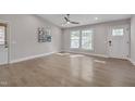 A neutral living room features gleaming hardwood floors and ample natural light at 6105 Bellow St, Raleigh, NC 27609