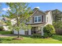 Charming home exterior with a well-manicured lawn and beautiful landscaping in a peaceful neighborhood at 617 Conover Rd, Durham, NC 27703