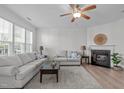 Cozy living room with fireplace, hardwood floors, and comfortable seating at 633 Democracy St, Raleigh, NC 27603