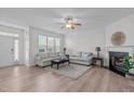 Bright living room with hardwood floors, fireplace, and large windows that provide plenty of natural light at 633 Democracy St, Raleigh, NC 27603