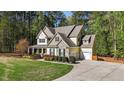 Beautiful exterior view highlighting the home's architecture, driveway, and well-maintained yard at 64 Thousand Oaks Ct, Clayton, NC 27527