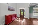 Bright foyer featuring hardwood floors, a stylish cabinet, and a welcoming front door at 64 Thousand Oaks Ct, Clayton, NC 27527