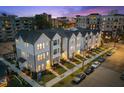 New townhome row with well manicured yards and landscaping, and convenient parking, offering curb appeal at 700 W North St # 101, Raleigh, NC 27603
