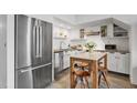Modern kitchen with stainless steel appliances, white cabinets, and a breakfast nook at 701 W Trinity Ave # 116, Durham, NC 27701