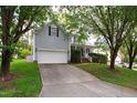 Two story home with a long driveway, garage, front porch and manicured hedges at 704 Voyager Pl, Durham, NC 27712