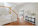 Inviting foyer with hardwood floors, staircase, and elegant console table at 704 Voyager Pl, Durham, NC 27712