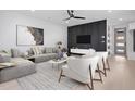 Modern living room featuring a stylish gray sofa, white armchairs, and contemporary decor at 732 Hopkins St, Durham, NC 27701