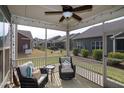 Inviting screened porch with comfortable seating, string lights, overlooking a landscaped backyard at 74 Revelstoke Dr, Garner, NC 27529