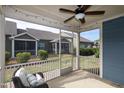Relaxing screened porch with ceiling fan, string lights, and comfortable wicker furniture at 74 Revelstoke Dr, Garner, NC 27529