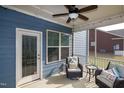 Cozy screened porch featuring cushioned wicker chairs, side table and outdoor access at 74 Revelstoke Dr, Garner, NC 27529
