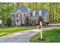 Beautiful brick home with lush green lawn and long driveway at 8309 Nantahala Dr, Raleigh, NC 27612
