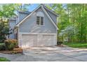 Spacious two-car garage with carriage-style doors and gray siding at 8309 Nantahala Dr, Raleigh, NC 27612